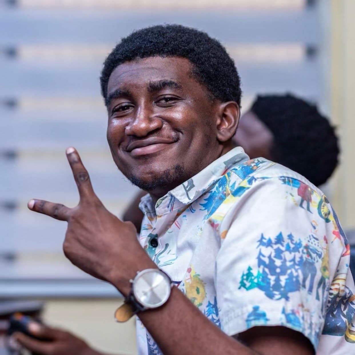 Jerry Amoah smiling, in a patterned short-sleeved shirt